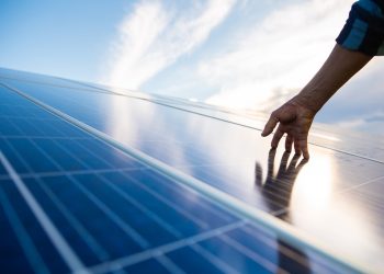 Hands on solar panel that generates energy