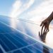 Hands on solar panel that generates energy
