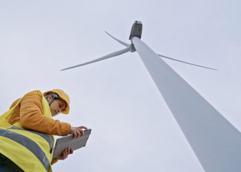 Female wind energy engineer working in wind farm. Renewable Energy Systems. Carbon neutrality and sustainable energy.