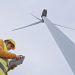 Female wind energy engineer working in wind farm. Renewable Energy Systems. Carbon neutrality and sustainable energy.