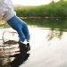 Environment engineer Collect samples of wastewater from industrial canals in test tube, Close up hand with glove Collect samples of wastewater from industrial canals in test tube. mobile water laboratory check