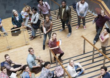 Portrait of university students standing together on staircase